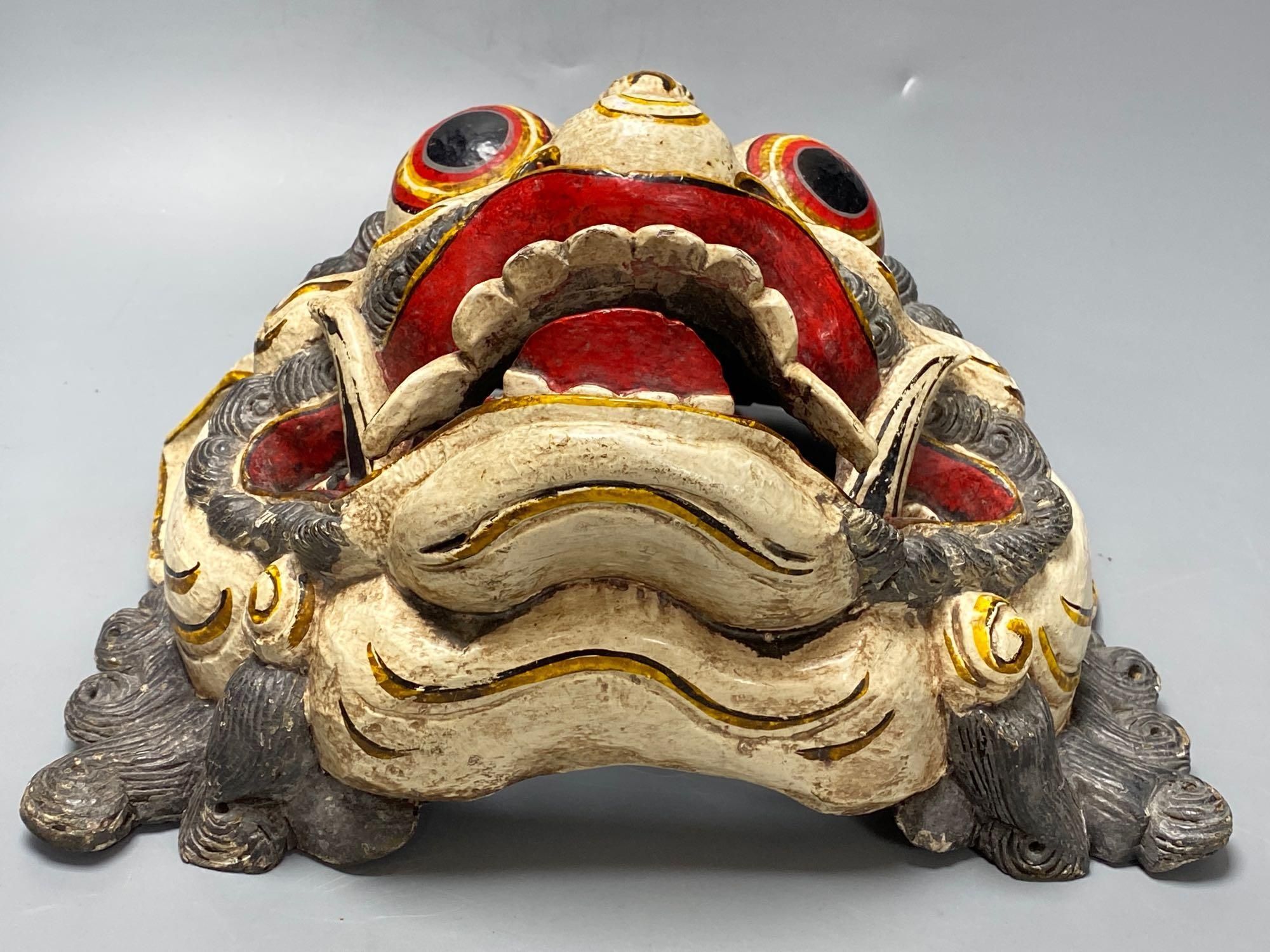 A Balinese carved and painted wood dragon mask, 28cm